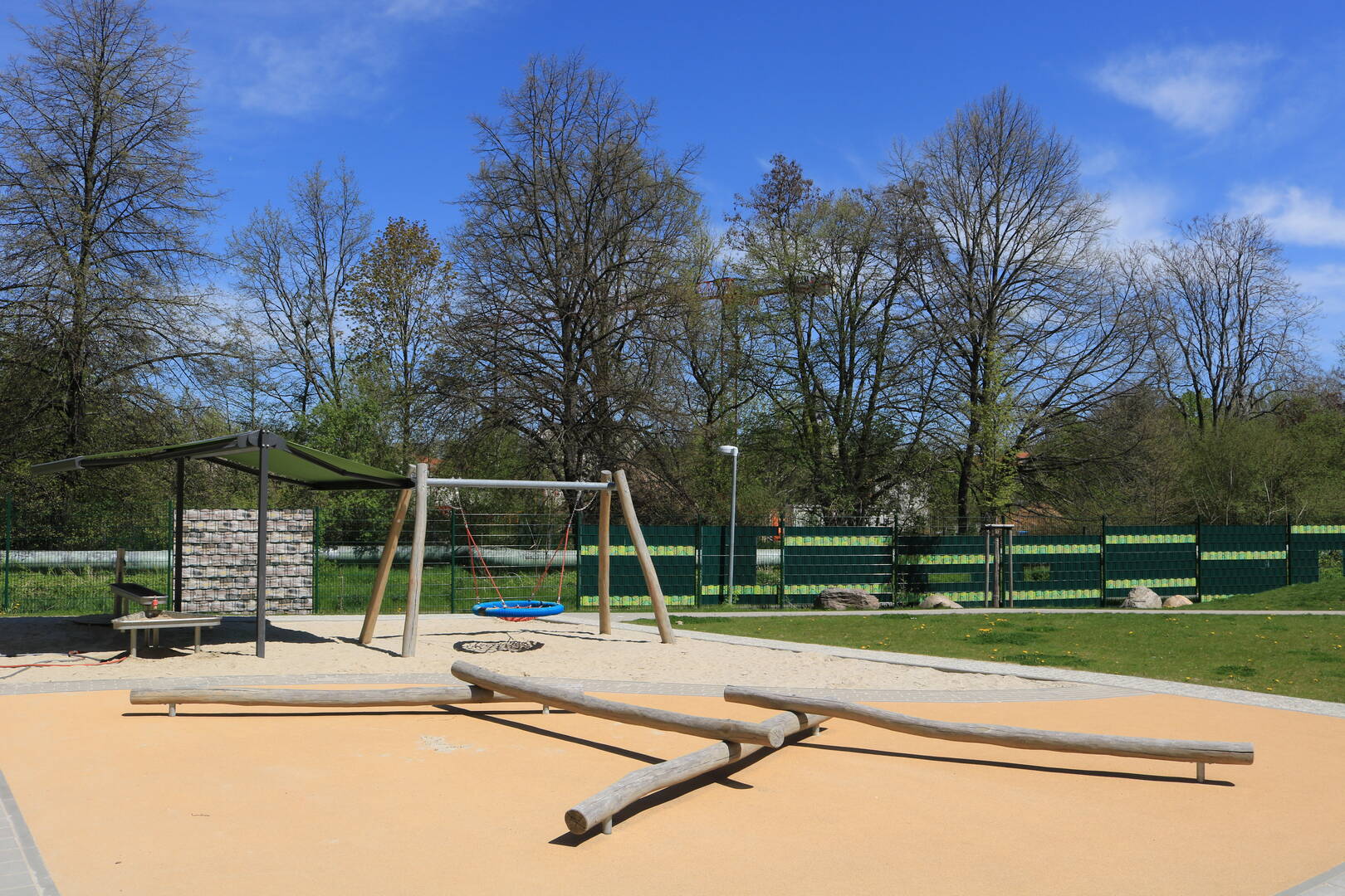 Garden with a playground and a swing